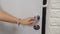 Woman hand opening and close white wooden door in office. Holding door handle. Full HD video motion