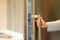 Woman hand opening fridge door in the kitchen