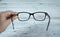 Woman hand optical glasses on table