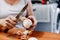 Woman hand peel fresh onion on brown table