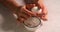 Woman hand peeling boiled egg in bowl