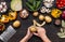 Woman hand peeling fresh potato bulb with peeler