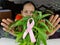 Woman hand on pink ribbon a cancer fighter , cover hands on cancer symbol Selective focus on ribbon.