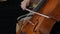 Woman Hand Playing cello With Cello Bow. Close up of female Hand Playing Cello With Cello Bow. Classical Orchestra