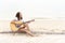 Woman hand playing guitar on the beach. Acoustic musician playing  classic guitar. Musical Concept