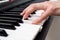 Woman hand playing a MIDI controller keyboard synthesizer close up