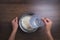 Woman hand is pouring water using measuring glass to cook jasmine rice. on wooden table