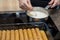 A woman hand prepares at home in the kitchen Bechamel sauce for cannelloni. Domestic life. Lifestyle cooking photos