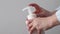 Woman hand press white plastic pump bottle and take cleaner foam. Dispenser with liquid foam soap