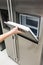 Woman hand pulling a cover of ice tray in silver metal finishing