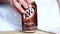 Woman hand put the aluminium AW root beer can