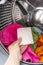 Woman hand put color absorbing sheet inside a washing machine.