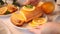 Woman hand put a fresh homemade baked sliced lemon cake on the table