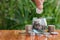 Woman hand putting coinIn the glass jar. Saving money wealth and financial concept, Personal finance, finance management, savings