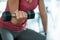 The woman hand raises the dumbbell to tighten the arm muscles. Exercise in a fitness center or house