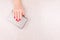 Woman hand with red manicure holding a small golden evening clutch. Holiday, party and celebration concept