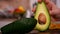 Woman hand separating the two halves of an avocado