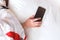 Woman hand sleeping and holding a mobile phone on the bed in bed