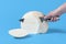 Woman hand slicing cheese with a knife. Block of fresh cheese