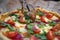 woman hand slicing pizza for pieces