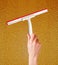 Woman hand with special squeegee for cleaning over glass