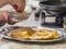 Woman hand sprinkling cinnamon and sugar on top french toast