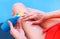 Woman hand  with sun cream on her legs. Girl holding sunscreen bottle on the poolside as applying moisturizing lotion