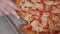 Woman hand takes delicious colorful pizza slice close view