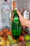 Woman hand taking bottle with Perrier water from fridge