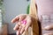 Woman hand taking painkiller pink ibuprofen pills , handful of overdose medicines