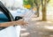 Woman hand throwing plastic bottle trash on the road,Environment and pollution campaign concept