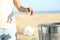 Woman hand throwing trash at the floor on the beach