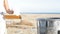 Woman hand throwing trash on the floor on the beach