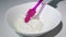 Woman hand turns whipped cream with a kitchen spatula