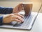 Woman hand type on Laptop Keyboard with Coffee cup