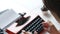 Woman hand typing on red vintage typewriter