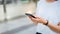 Woman hand using black smartphone. The concept of using the phone is essential in everyday life.