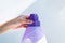 Woman hand using liquid laundry softener detergent washing cloth