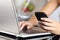 Woman hand using a smart phone and typing a laptop at home