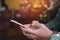 Woman hand using smartphone in cafe shop background. Business, financial, trade stock maket and social network