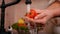 Woman hand washing handful of cherry tomatos at the kitchen sink - closeup