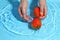 Woman hand washing tomato in water. Wash vegetables before cooking