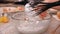 Woman hand whip thick foam of egg whites in a glass bowl