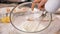 Woman hand whisk egg whites in a glass bowl with mixer