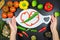 Woman hand and white cutting board framed the vegetables