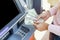 Woman hand withdrawing money from outdoor bank ATM