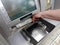 Woman hand withdrawing money from outdoor bank ATM