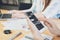 Woman hand working with phone and laptop on wooden desk in office. can be used on an ad