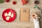 Woman hand writing 2024 PLANS on notebook with Christmas cookies on table. Xmas, Happy New Year, Goals, Resolution, To do list,