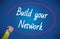 Woman hand writing build your network with marker